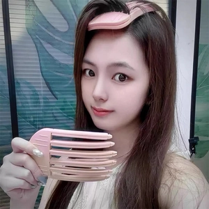 Detail of pink gradient hair root clip with multi-comb design for voluminous hairstyles