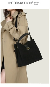 Detail of black suede shoulder bag with gold clasp shown on a model in trench coat