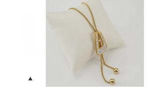 Detailed view of long gold tassel necklace featuring trapezoid pendant with pave-set crystals