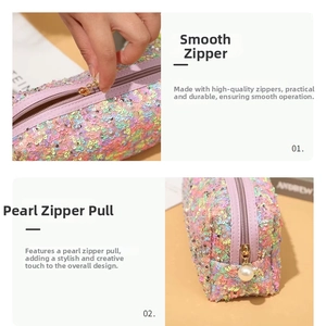 Close-up of sequin makeup bag featuring a smooth gold zipper and a faux pearl charm