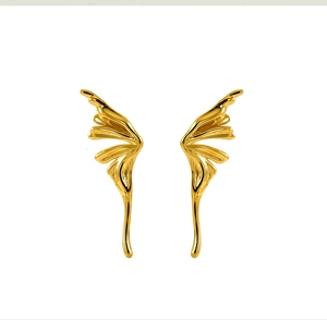 Macro detail of elegant golden butterfly wing earrings in minimalist titanium steel design