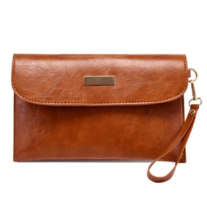 Close-up of brown PU leather wristlet clutch with gold metal plate and detachable strap