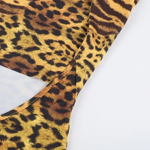 Close-up detail of leopard print fabric texture and high-quality stitching on a beach dress