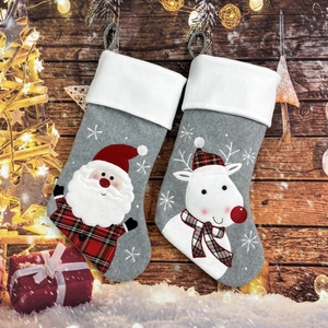 Detailed view of grey felt Christmas stockings with 3D Santa and Reindeer appliques
