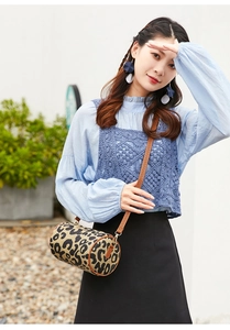 Detail of vintage leopard print cylinder bag styled with a blue vest and shirt
