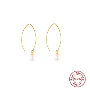 Detail of 925 sterling silver gold-plated hooks with elegant white pearl pendants