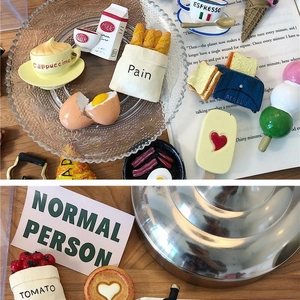 Detailed flat lay of 3D miniature food magnets including coffee, bread, and toaster sets