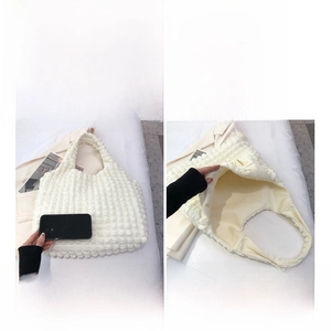 Detailed internal view of white popcorn texture handbag showing spacious storage capacity