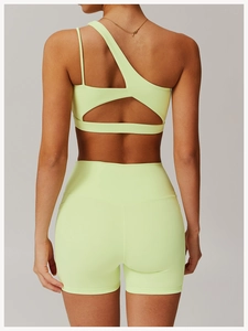 Rear view of high-waisted yoga shorts and asymmetric sports bra in neon green
