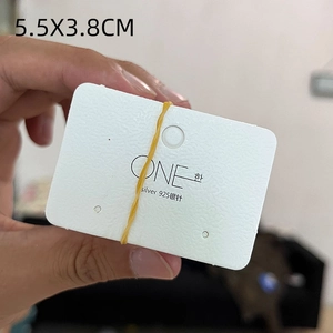 Detailed view of white embossed jewelry card with silver 925 logo and size 5.5x3.8cm