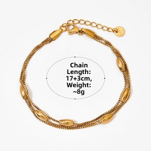 Detail of double-layer gold stainless steel box chain bracelet with olive beads