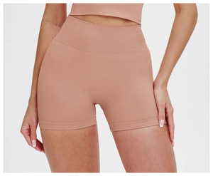 Close-up of high-waisted seamless yoga shorts in nude pink showing ribbed texture and fit