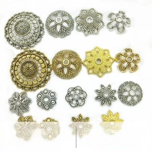Detailed macro view of vintage alloy bead caps and flower spacers for DIY jewelry making