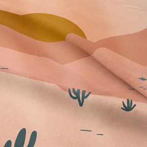Detail of twill fabric showing desert landscape print with dunes and sunset