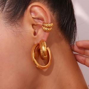 Macro shot of 18K gold plated S925 silver hoop earring and textured ear cuff set on model
