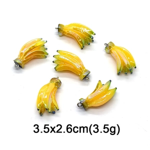 Detail of yellow banana fruit charms with size 3.5x2.6cm and weight 3.5g for DIY jewelry