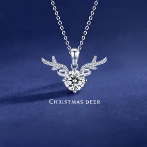 Macro detail of Christmas deer pendant with brilliant cut stone on blue velvet