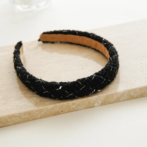 Detail of black tweed headband with gold metallic thread and woven diamond pattern