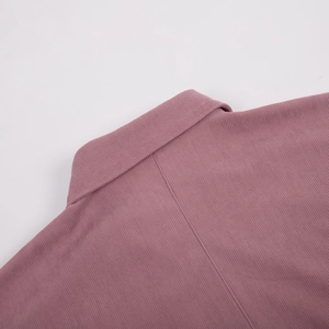 Detailed view of the dusty pink corduroy collar and shoulder stitching of the dress