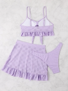 Detailed flat lay of lavender three-piece bikini set with ruffle trim and eyelet embroidery