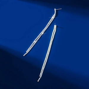 Detailed close-up of sparkling rhinestone long fringe earrings with silver-tone finish