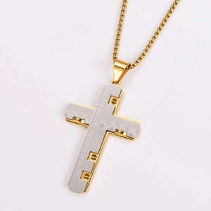 Macro detail of industrial cross pendant with two-tone gold and silver metal textures