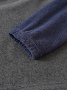 Detail view of elastic cuffs and fleece texture on two-tone tactical pullover jacket