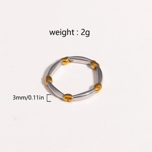 Macro detail of 3mm wide mixed gold and silver ring with heart and leaf accents