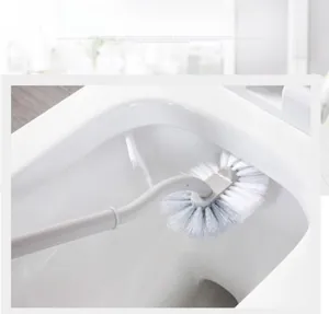 Detail of flexible white PP bristles cleaning the rim and hard-to-reach areas of a toilet
