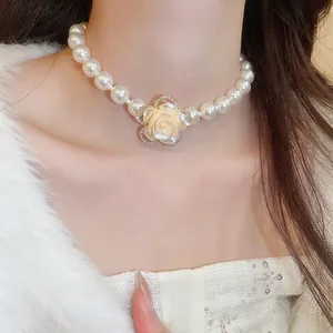 Elegant multi-layer pearl necklace with a vintage diamond-encrusted rose floral pendant
