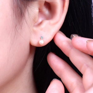 Elegant S925 silver stud earrings featuring round freshwater pearls and zircon accents