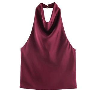 Detail of burgundy satin halter top featuring a draped neckline and silky fabric texture