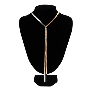 Detail of two-tone gold and silver snake chain necklace with Y-shaped tassel design