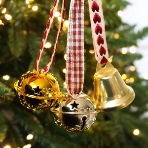 Champagne gold Christmas star bells with red heart plaid ribbons on a tree