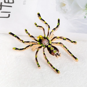 Exaggerated spider brooch with green enamel stripes and iridescent stone inlay