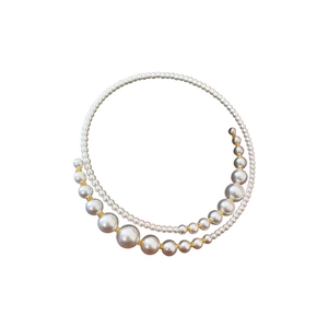 Irregular crossover pearl choker featuring white pearls and golden beads in a spiral design