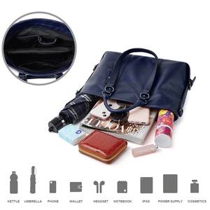 Detail showing high-capacity interior of navy blue tote bag with various accessories