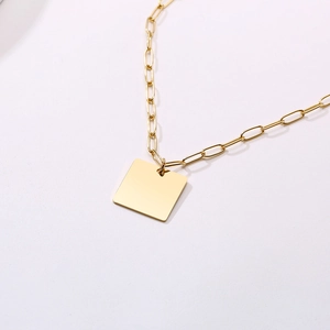 Detail of 18k gold plated paperclip chain necklace with a polished square tag pendant