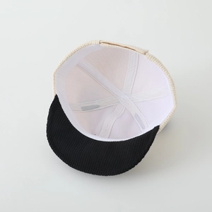 Detail view of the interior corduroy baby cap showing stitching and reinforced seams