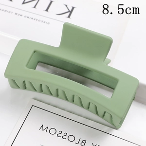 Detailed macro view of an 8.5cm matte green square hair claw clip with comb teeth