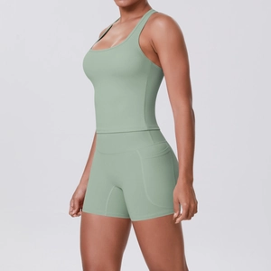 Detail view of light green athletic set showing racerback top and shorts with side pockets