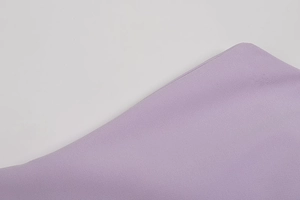 Detail of purple crepe fabric showing elegant grain texture and high-quality material finish