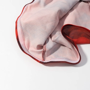 Detailed macro view of the floral print fabric with durable overlock stitching edges