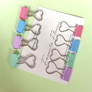 Pink heart-shaped hollow binder clips in assorted macaron colors for office organization