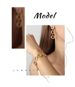 Detailed view of vintage gold geometric ring earrings and matching bracelet set