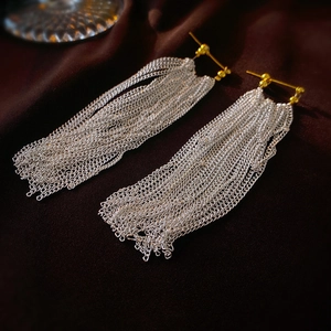 Exaggerated metal tassel earrings with gold studs and layered silver chains