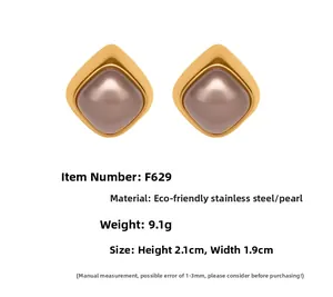 Detail view of geometric rhombus earrings with faux pearls and product measurements