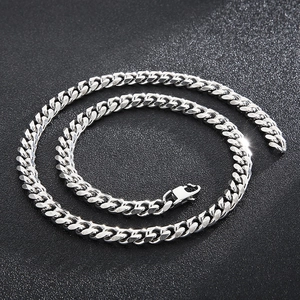 Close-up of a silver titanium steel Cuban chain necklace with a lobster clasp closure