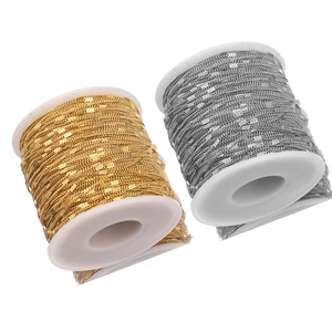 Macro shot of gold and silver stainless steel curb chain rolls for DIY jewelry making