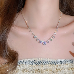 Close-up of sparkling geometric round zircon pendant necklace worn on model neck